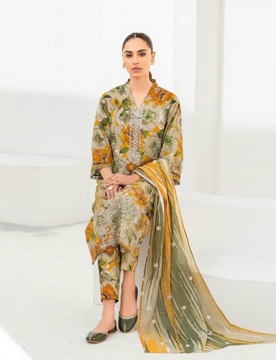 Woman wearing a floral outfit with a yellow dupatta on a white background