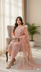 Woman in a peach embroidered outfit sitting on a chair in a well-lit room with curtains and a plant.